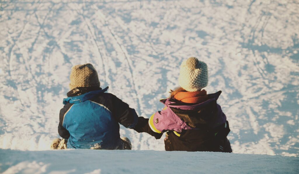 Children sitting and watching downhill route