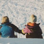 Children sitting and watching downhill route